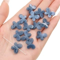 Translucent dark grey acrylic butterfly beads for handmade jewelry on a palm - Navy Blue