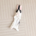 Flat lay detail of a black and white plush bunny storage bag on a striped rug - 30cm (Unstuffed) / Black and White (Sitting Shell)
