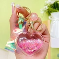 Pink heart-shaped liquid quicksand keychain with glitter flakes and golden lobster clasp - Pink