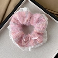 Pink plush scrunchie with white lace trim and a small bow detail on beige fabric - Bowknot Style / Pink