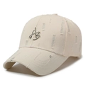 Distressed beige cotton baseball cap featuring black AB letter embroidery and ripped details - Light Beige
