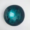 Detail view of artistic shell coconut bowl with deep blue-green feather-like pattern - Blue Feather Style