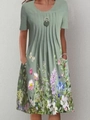 Short sleeve A-line midi dress in sage green with floral print and side pockets - S / Top And Bottom / Green Butterfly Floral