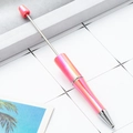 DIY beadable ballpoint pen featuring a metallic pink gradient finish and silver accents - Peach Pink Gradient