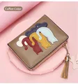Detail of coffee brown PU leather wallet featuring five colorful cartoon cat appliques - Apricot
