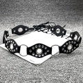Close-up of Y2K vintage leather belt with silver metal rings and punk rivet details - Rivet Eyelet Style / Black