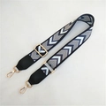 Detail of geometric pattern bag strap with gold metal buckles and leather connectors - Silver Clasp / Aqua Blue with Black Leather End