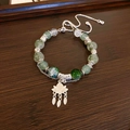 Ethnic style bracelet featuring green beads and a silver lotus charm with tassel detail - Double Layer Lotus