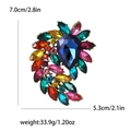 Vintage alloy brooch with colorful rhinestones and dark blue pear-shaped center stone - Rainbow