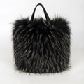 Faux raccoon fur handbag in black plush with slim leather handles on white background - Black with White Tips