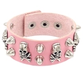 Close-up of pink PU leather bracelet with silver skull charms and metallic cone studs - Pink Skull