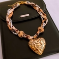 Macro view of leopard print heart pendant on beaded necklace over black leather background - 29# Gold Necklace Leopard Heart