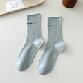 Minimalist light blue cotton crew socks featuring black aimin letter embroidery - One Size / Milky Blue