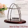Medium sail-shaped Newton's cradle with silver metal balls and red oval base - Medium / Sailboat Shape