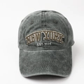 Detail of embroidered NEW YORK EST. 1625 text on washed cotton denim baseball cap - Dark Green
