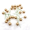 Detailed view of golden Christmas foam berries on white faux fur background for DIY crafts - 15mm / Gold