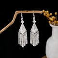 Vintage silver tassel earrings with bohemian flower design on a rustic wood branch - Vintage Ethnic Long Tassel Style (E5816)