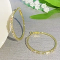 Luxurious gold hoop earrings with baguette-cut zircons leaning on white ceramic - Rectangle Zirconia Large Hoop (K-1174)