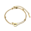 Double-layered golden stainless steel bracelet featuring metal beads and letter D charm - Letter D