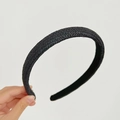 Close-up of black handcrafted woven headband with detailed texture held by hand - Straw Woven Headband / Black