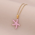Detailed close-up of a pink starfish pendant with white polka dots on a gold chain - Pink Dotted Starfish
