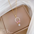 Detail of bow pendant with pink heart stones and pearl on luxury jewelry display - Bow Pearl Necklace (D341)