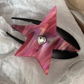 Macro detail of star-shaped pink marble acetate hair claw with a heart rhinestone - Pink Marble Star Claw Clip