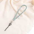 Elegant silver and blue rhinestone phone strap chain with metal clasp on beige fabric - Blue