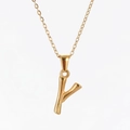 Close-up of golden stainless steel Y-letter pendant with bamboo texture and cross chain - Letter Y