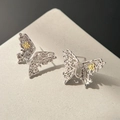 Detailed close-up of hollow silver butterfly stud earrings with gold flower accents - EH0201/Silver Two-Tone Hollow Butterfly Stud