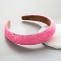Close-up of padded pink headband with sparkling sequins and brown non-slip lining - Pink