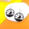 Detail of Halloween acrylic earrings featuring black cat and bat silhouettes on orange - Hollow Cat