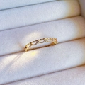 Elegant gold bow ring with pink and white gemstones in a jewelry box presentation - J5222-Hollow Pink Zirconia Gold
