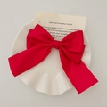 Elegant red satin bow hair clip placed on a white ceramic plate with a book background - Red Satin Bow Hair Clip / Red