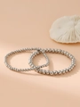 Detailed view of silver stainless steel bead bracelet set on a beige textured surface - Silver Beaded Style (Pair)