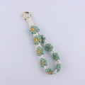 Detail of handmade woven daisy keychain with green petals and golden spring ring clasp - Dark Green