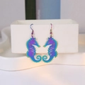 Detail of colorful laser-cut iridescent seahorse earrings with metallic gradient finish - Iridescent Seahorse 2