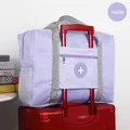 Violet foldable travel bag on suitcase handle with mesh pockets and airplane logo - Purple