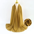 Long mustard yellow pearl chiffon scarf shown on gold mannequin with texture detail - Mustard Yellow