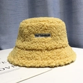 Winter yellow lamb wool bucket hat with embroidered square label on white surface - One Size / Yellow