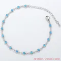 Macro shot of silver chain anklet with 4mm blue stones and 50mm adjustable extension chain - Bracelet / Platinum / Turquoise Blue Zirconia