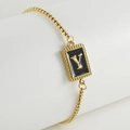 Detail of adjustable gold chain bracelet featuring a square letter Y charm in black enamel - Y-Black