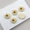 Detail of five cream resin flower charms with knitted texture for DIY phone case crafts - Off White