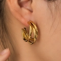 Close-up of triple-layered golden hoop earrings featuring a vintage minimalist design - Triple Layer Line Stacking (BJGE0701)