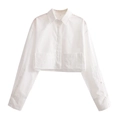 Detail of white long sleeve cropped shirt featuring button closure and two front pockets - White / S