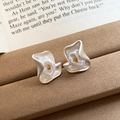 Detail of silver floral earrings with pearl accents on a rustic display stand - 4# Silver White Petal Pearl Silver Earring Post (WE4921)