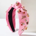 Dettaglio della fascia in maglia rosa con strass scintillanti e scritta Love dorata - Rosa