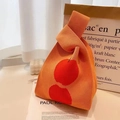 Orange knitted knot bag with bold red polka dots on textured jacquard material - 20*35cm / Orange Polka Dot