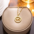 Gold titanium steel necklace with crystal-encrusted MK pendant on jewelry box - 8912 Gold Mk