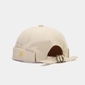 Detail of beige canvas docker hat featuring yellow airplane embroidery and metal strap buckle - Adjustable / Beige